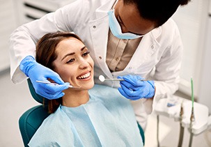 Woman in dental chair undergoing examination