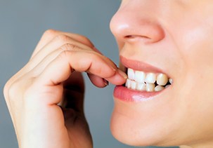 Closeup of patient biting nails