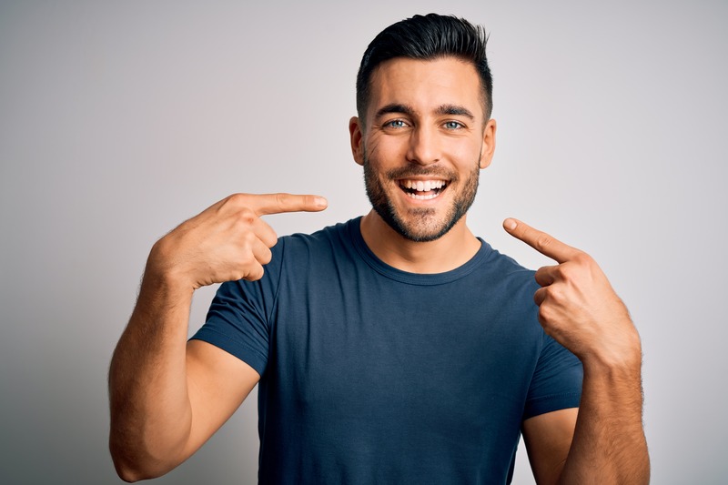 Patient smiling with their new dental implants